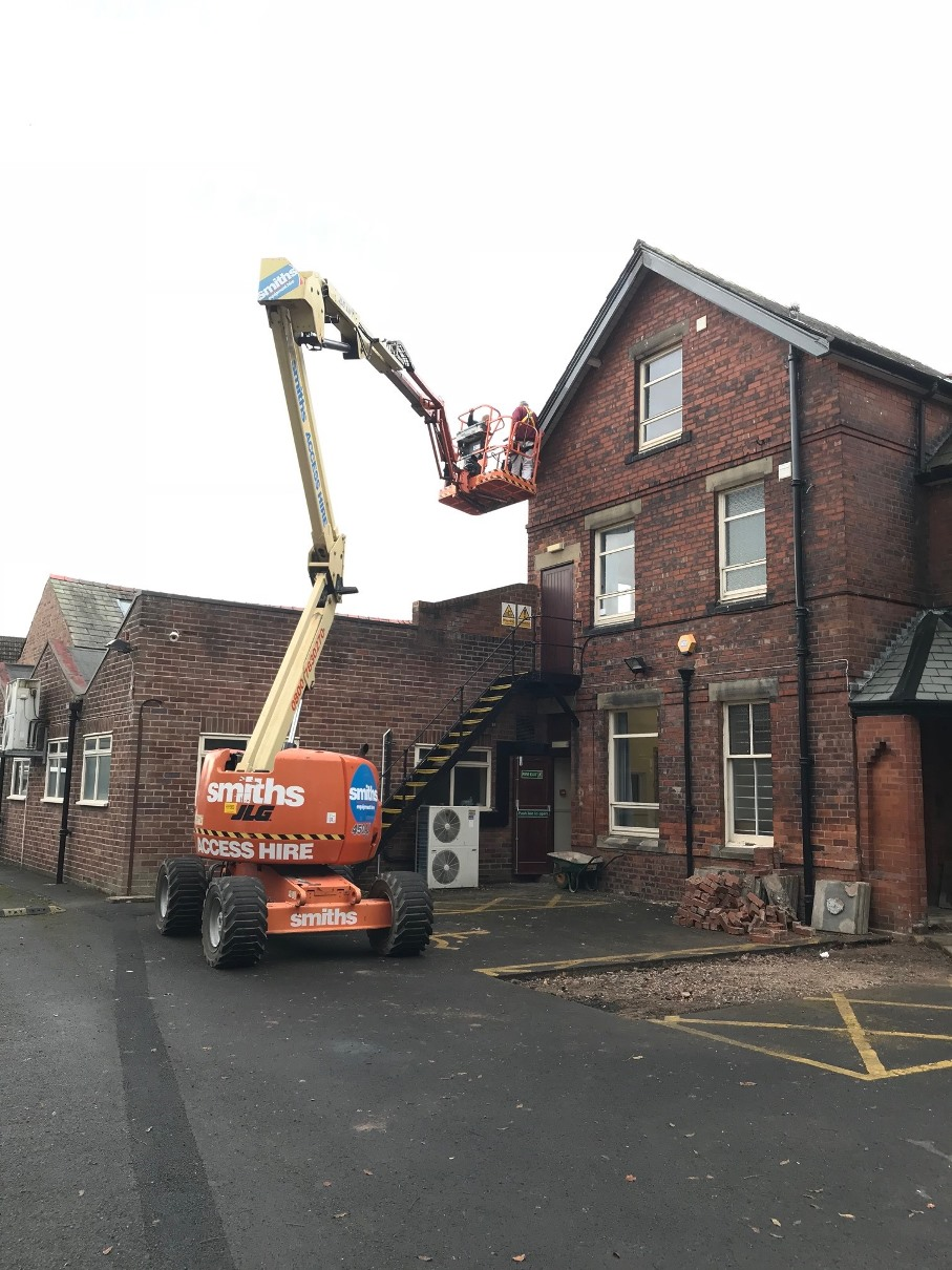 Cherry Picker inspecting the roof